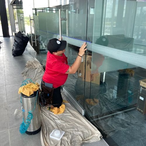 Sun Shade & Graphics window technician, installing commercial window tinting