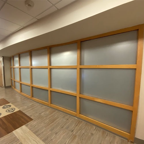 Large interior commercial window paneling, treated with frosted window tinting.