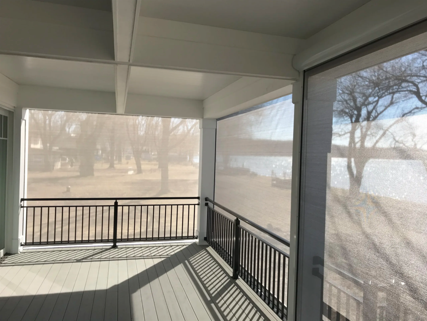 A completely screened-in porch in a lakeside house.